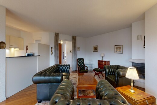 living area with wood finished floors and a fireplace