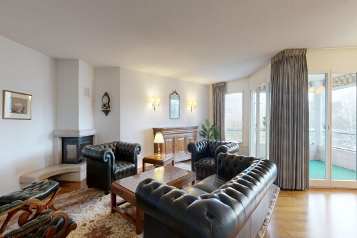 living area with light wood finished floors and a multi sided fireplace