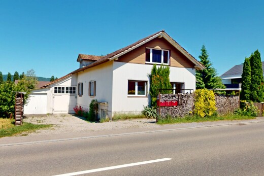 außenansicht mit property visible, day time, garage angeschlossen, auffahrt, und stuckverkleidung