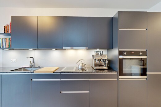 küche mit flat panel cabinets, schränke mit flachen paneelen, ofen, waschbecken, und dark countertops