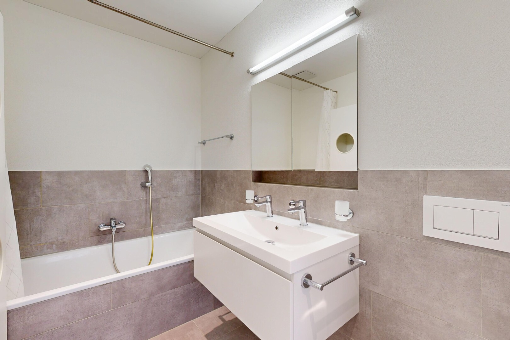 bathroom with a bath, vanity, a tile shower, and tile walls