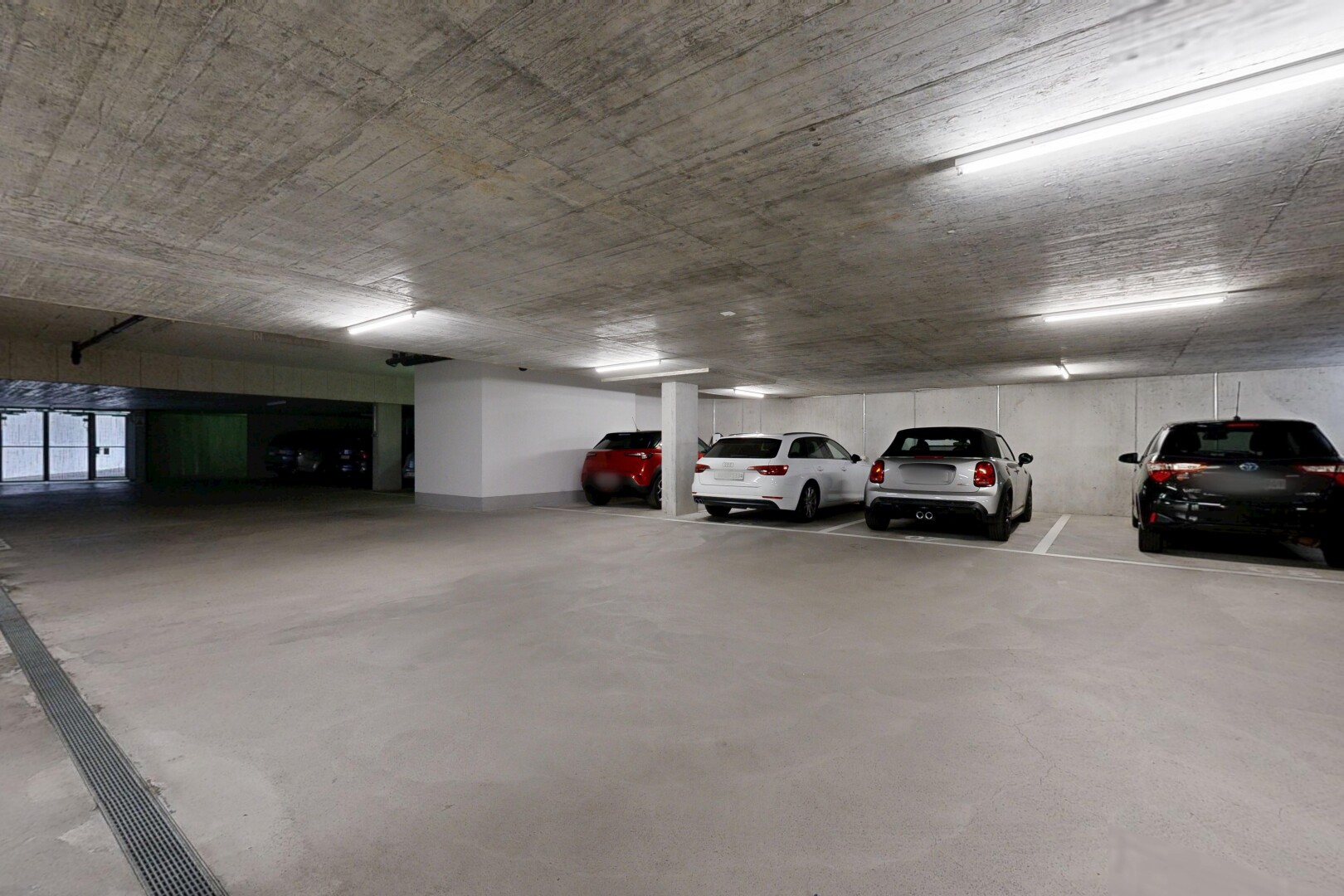 view of parking featuring a parking garage