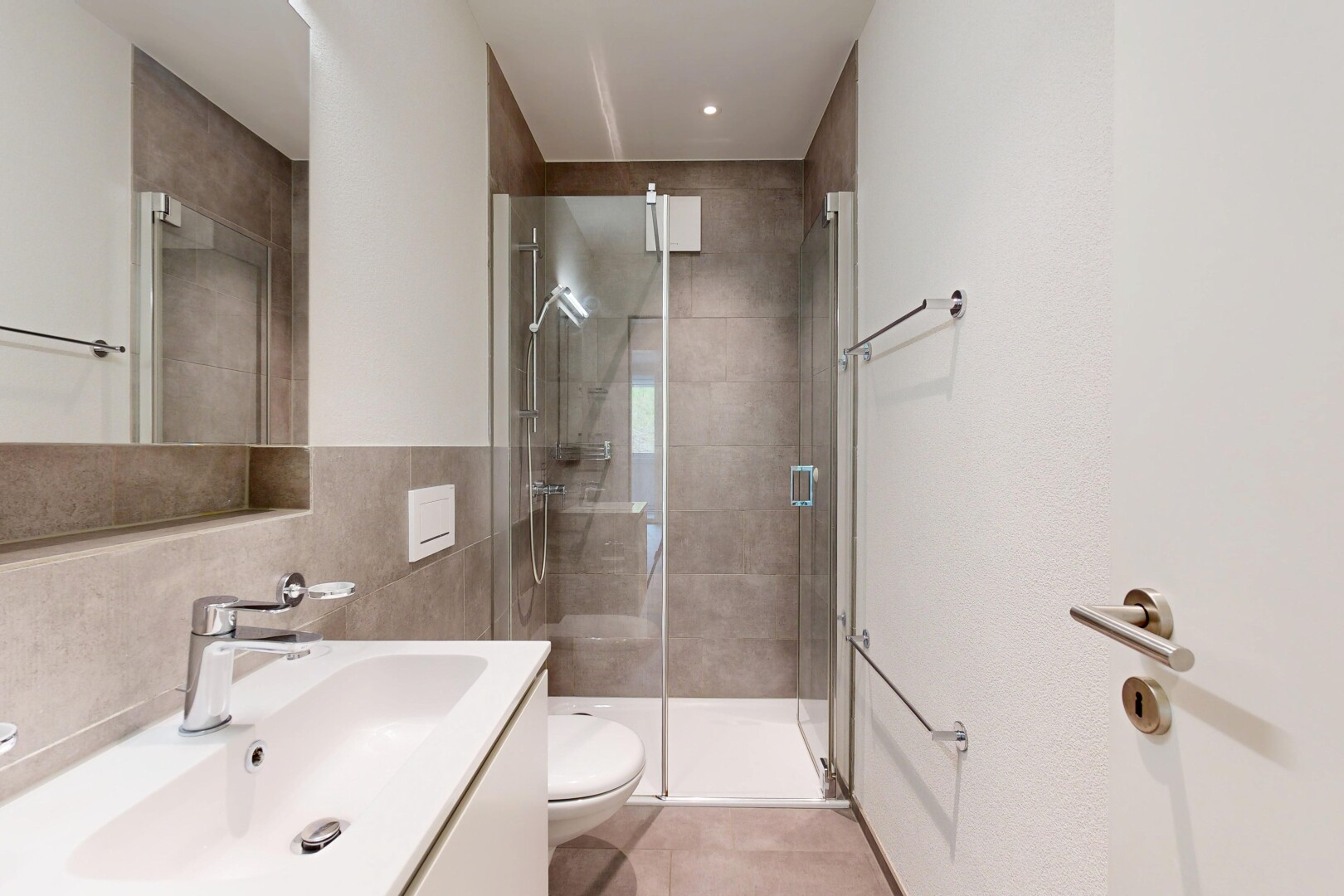 full bathroom featuring vanity, a shower stall, and tile walls