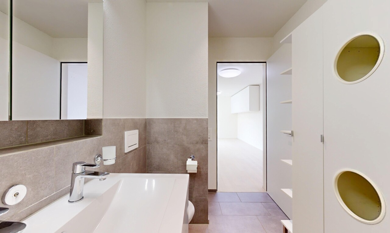 full bath with vanity, tile walls, and light tile patterned floors