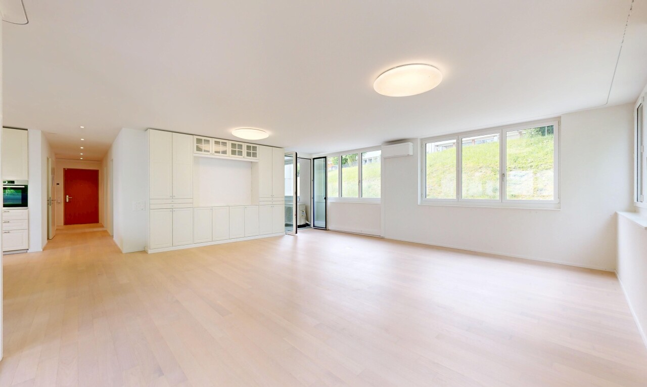 unfurnished room featuring light wood finished floors and a wall unit AC