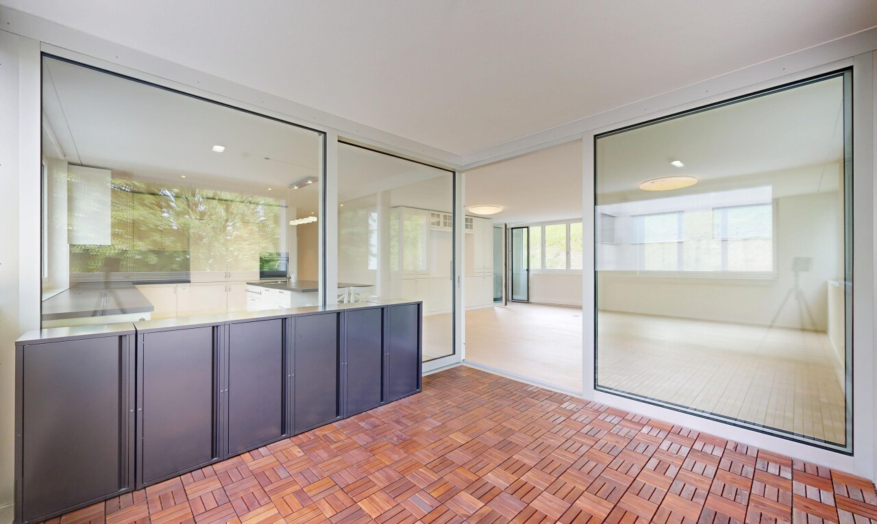 patio / terrace featuring a sunroom