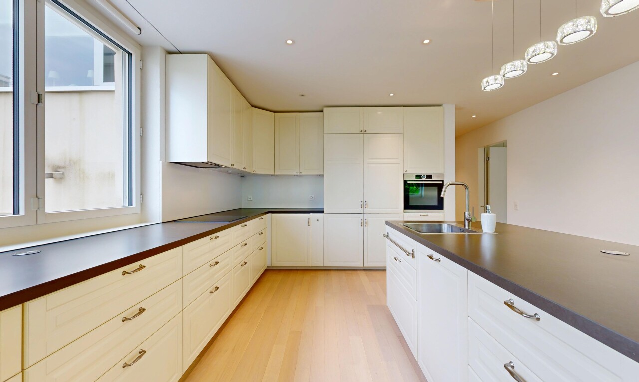 kitchen featuring dark countertops, stainless steel oven, light wood-style flooring, and white cabinetry