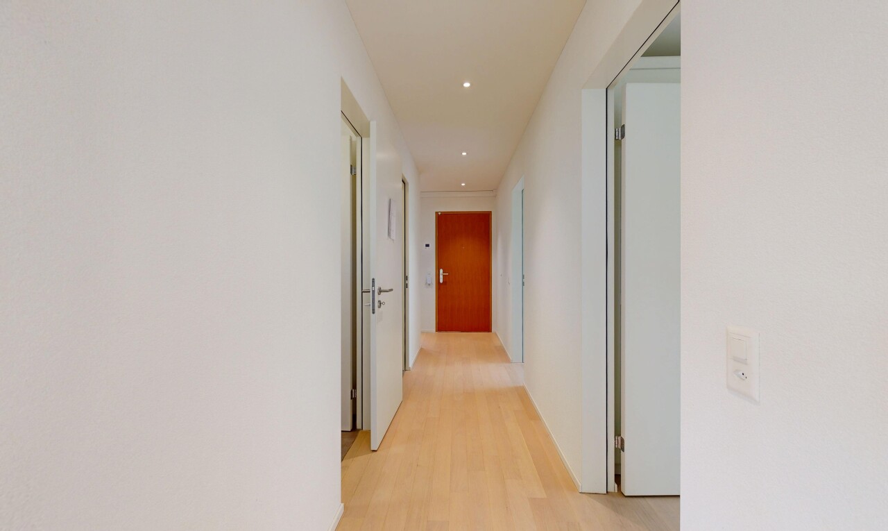 corridor with light wood-style flooring and recessed lighting