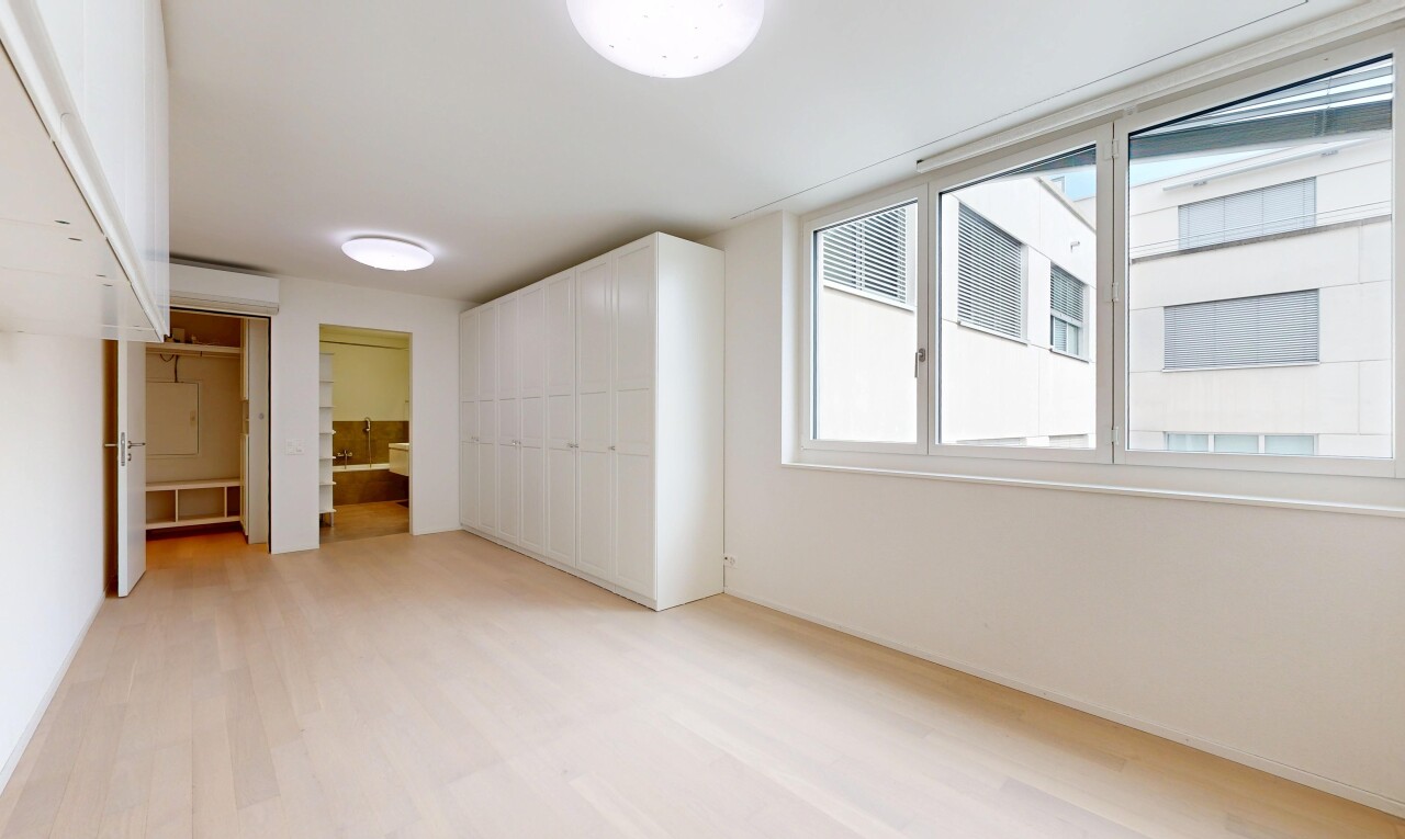 spare room with light wood finished floors and a wall mounted AC