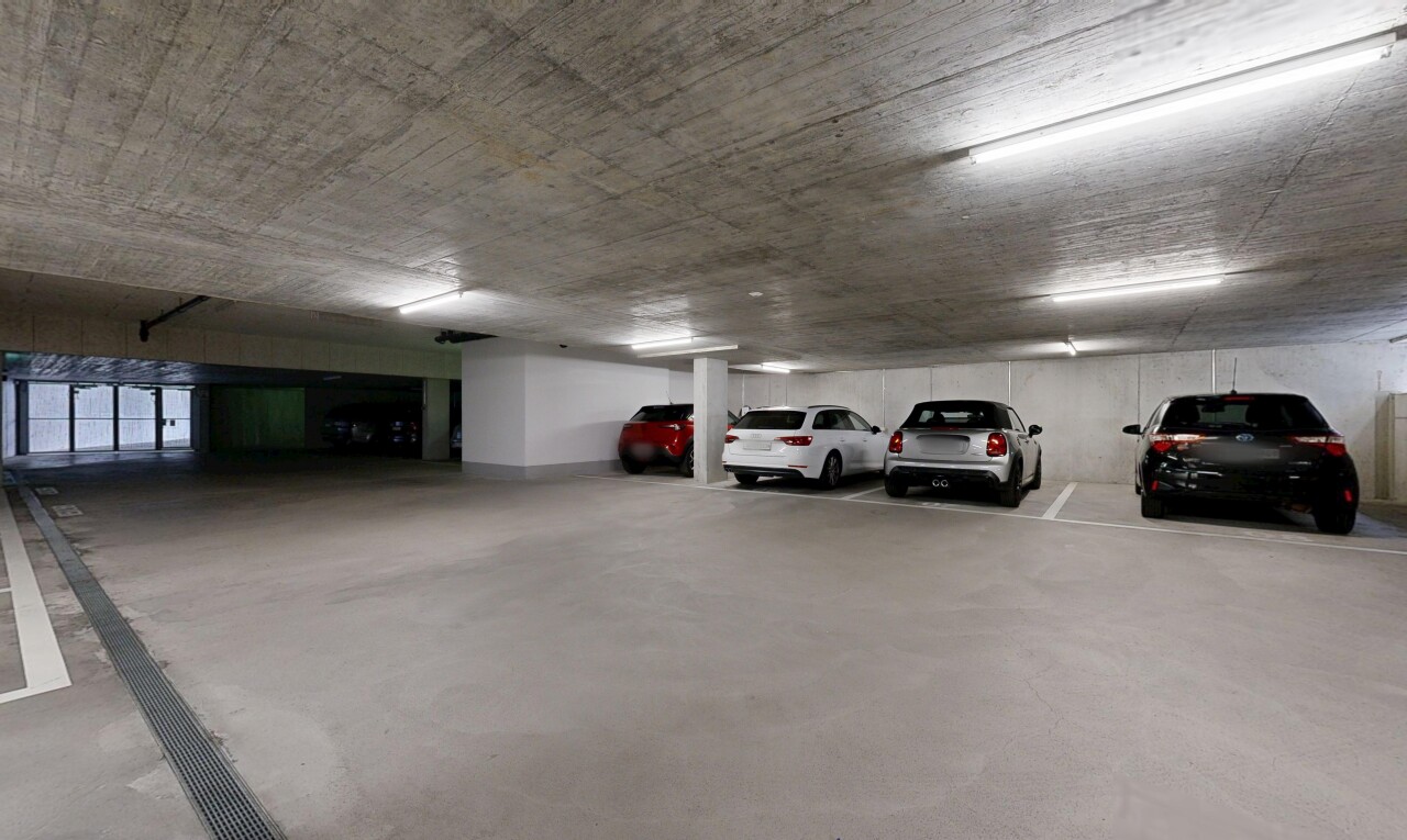 view of parking featuring a parking garage