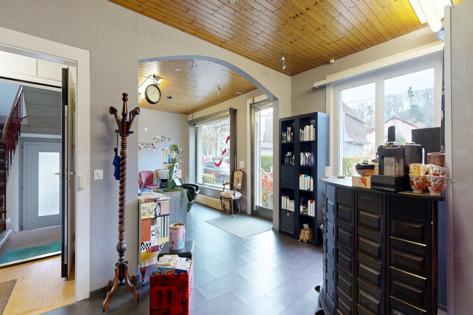 kitchen featuring wood ceiling, dark floors, and arched walkways