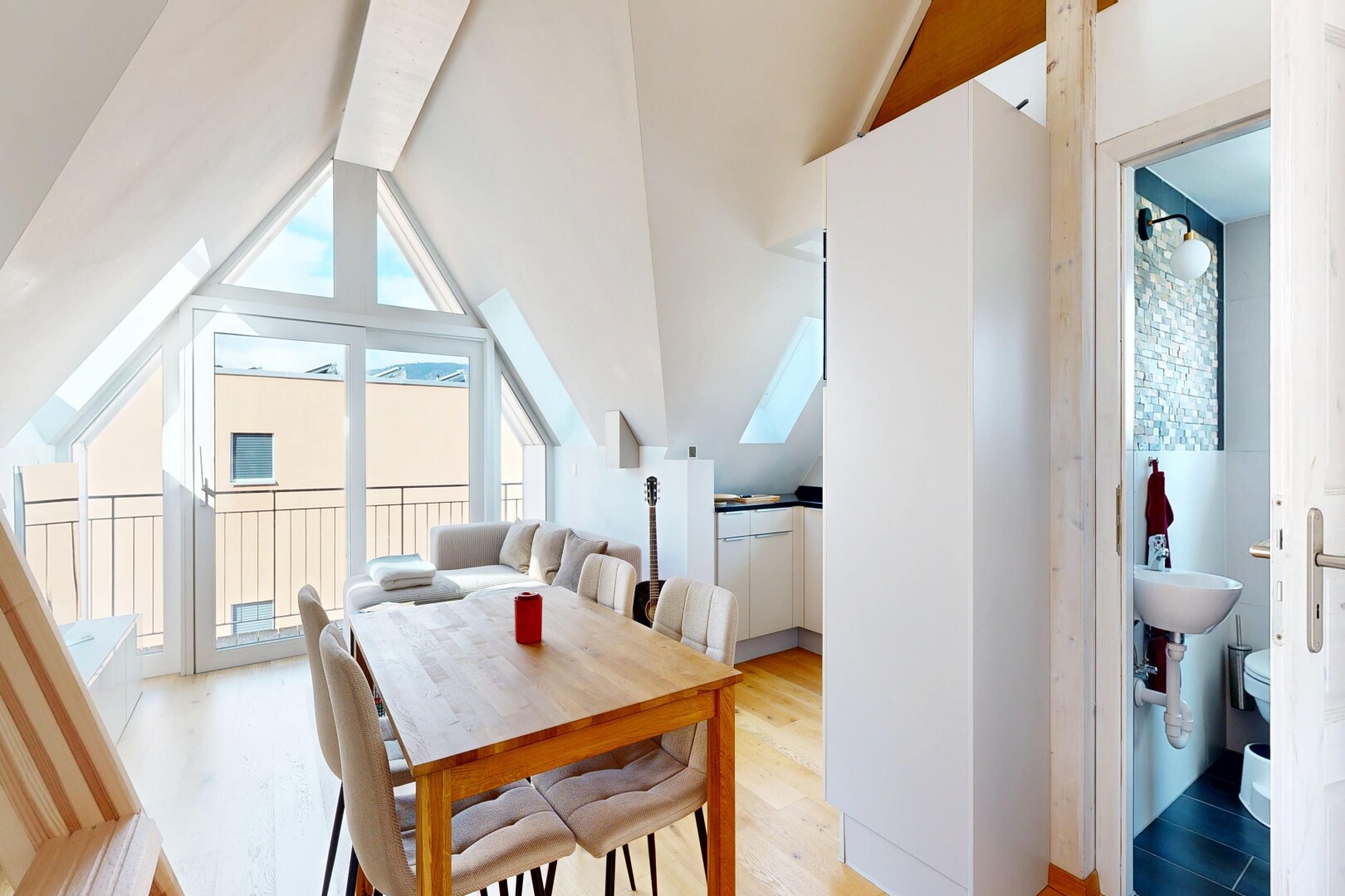 dining area with light wood finished floors and lofted ceiling