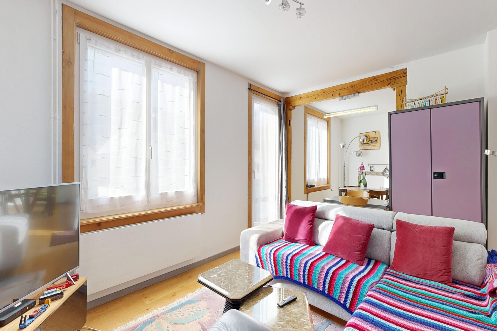 living area with light wood-style floors and baseboards