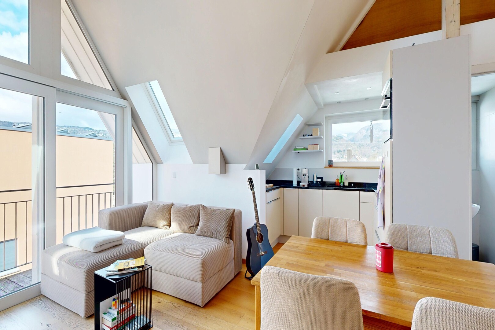 living room with lofted ceiling, light wood finished floors, and a skylight