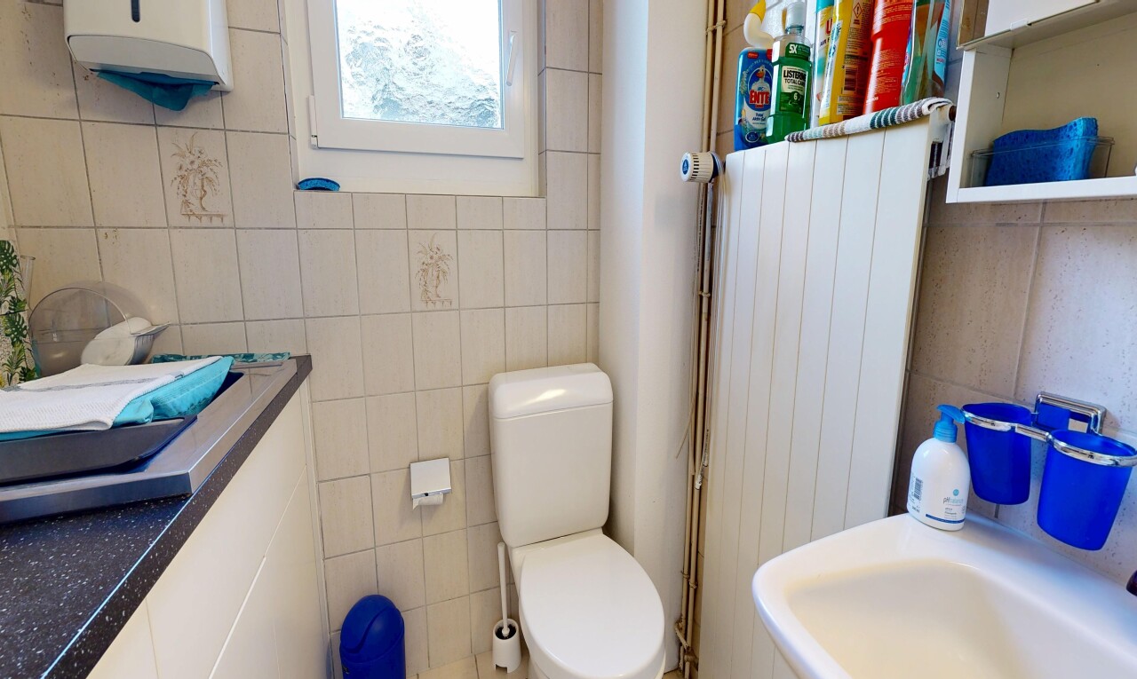bathroom with tile walls and water heater