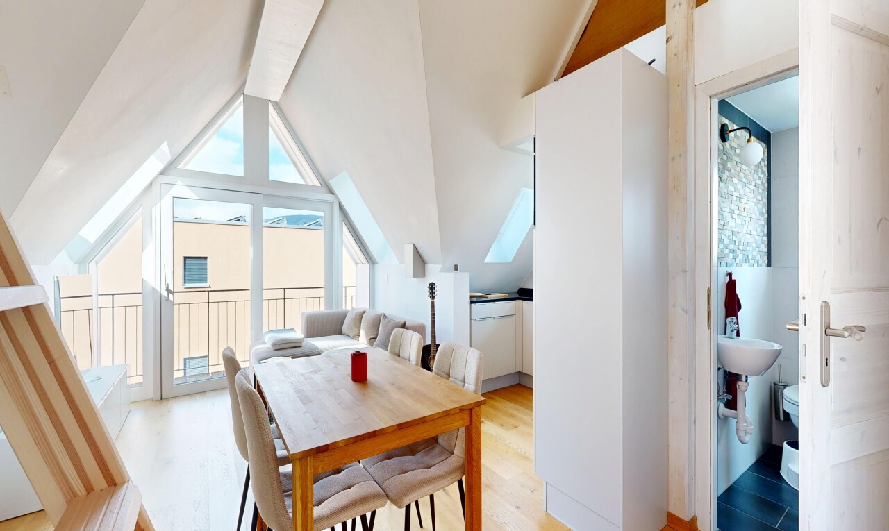 dining area with light wood finished floors and lofted ceiling