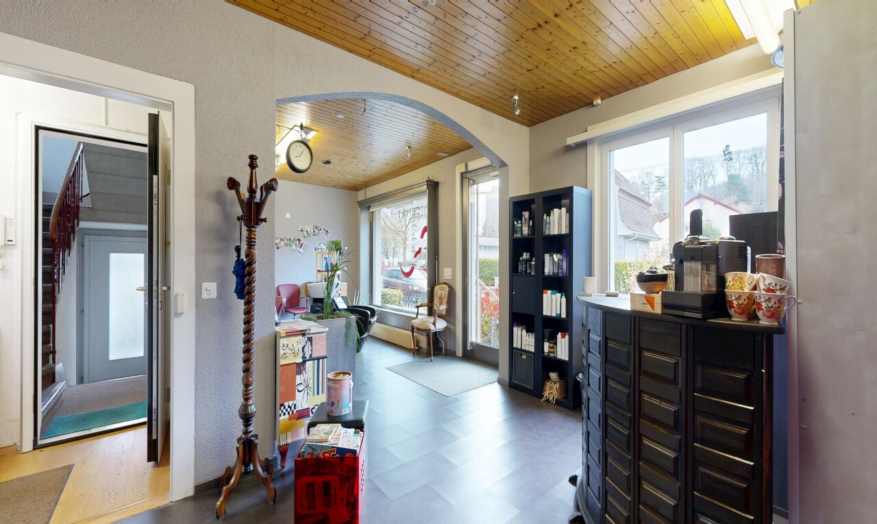 kitchen featuring wood ceiling, dark floors, and arched walkways