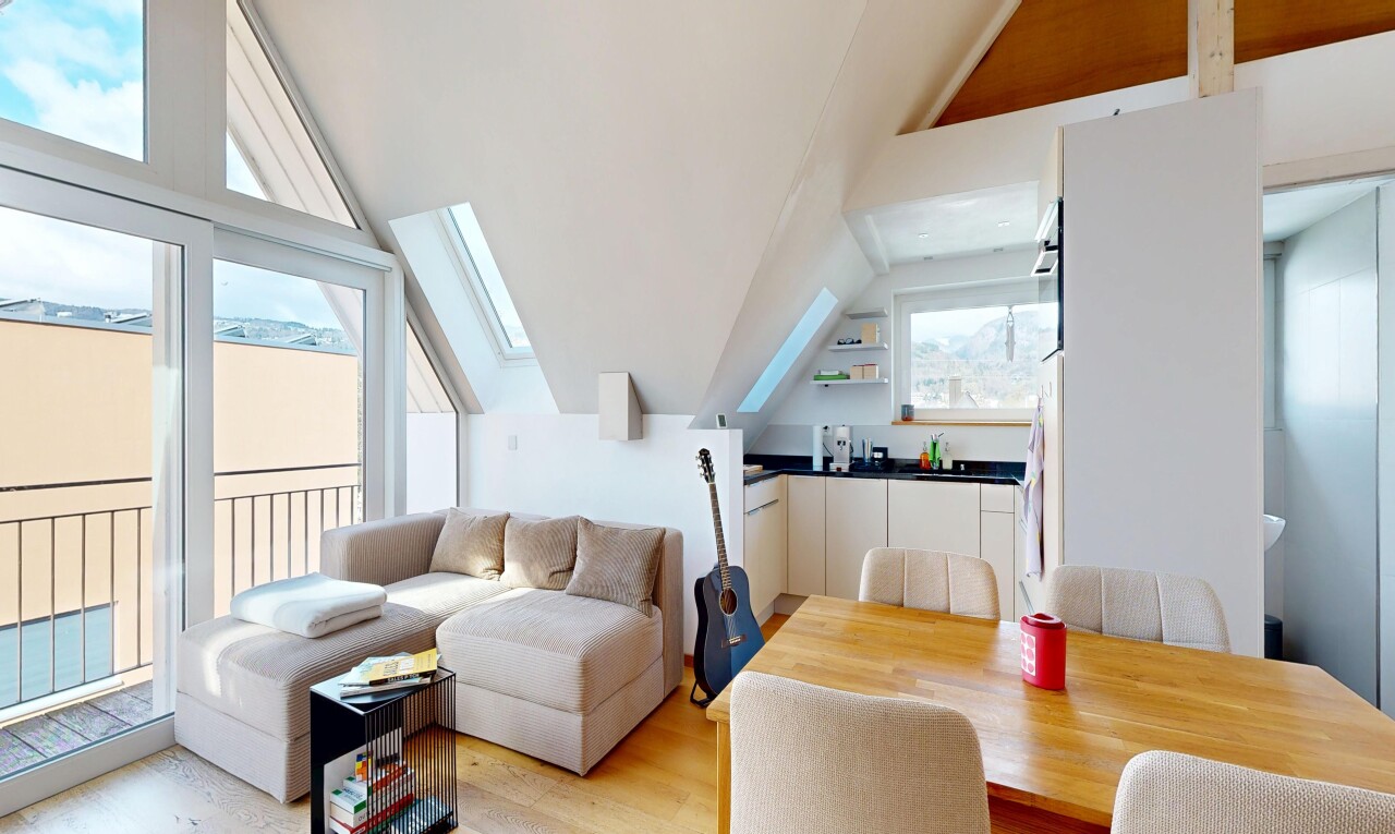 living room with lofted ceiling, light wood finished floors, and a skylight