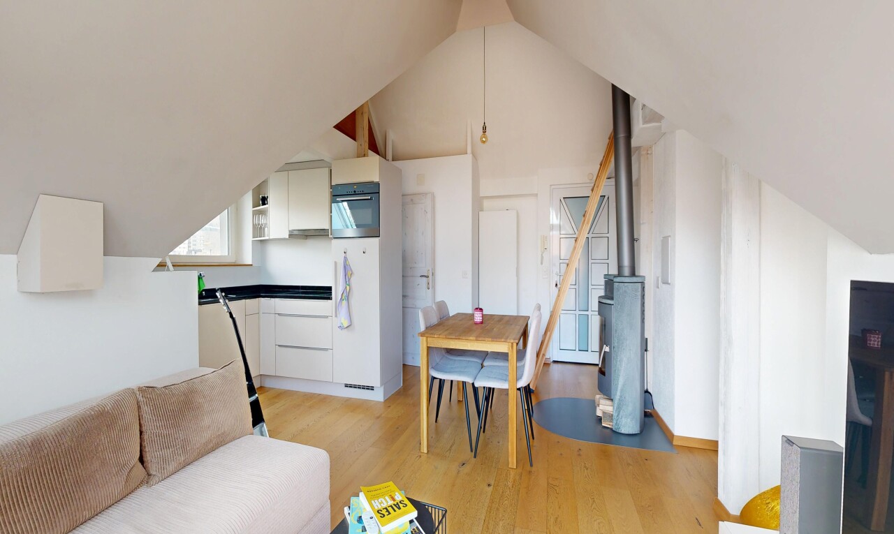 living area with light wood-style floors and a high ceiling