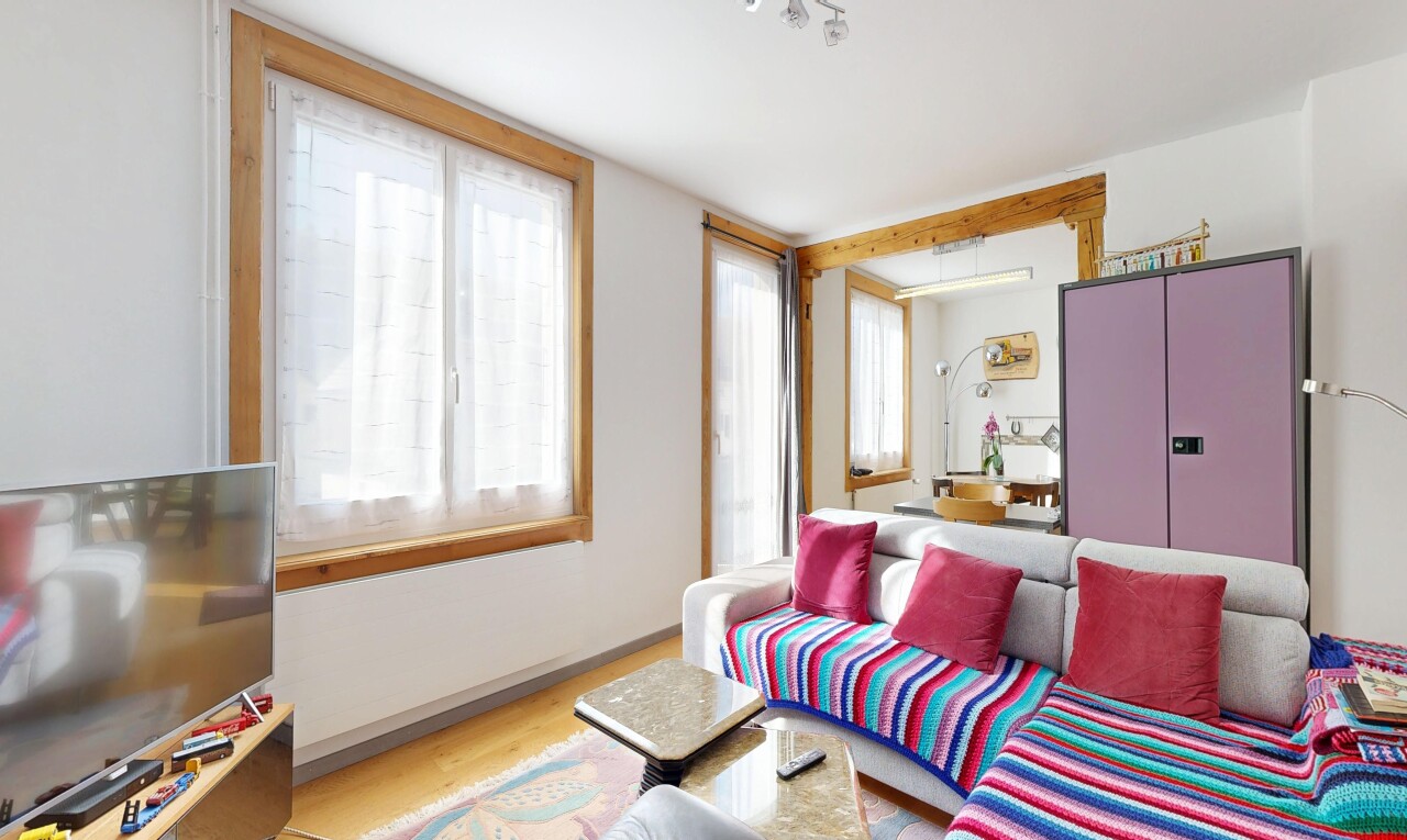 living area with light wood-style floors and baseboards
