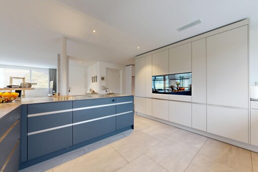 dual tone kitchen with modern cabinets, light countertops, dual tone cabinetry, recessed lighting, and light tile patterned flooring