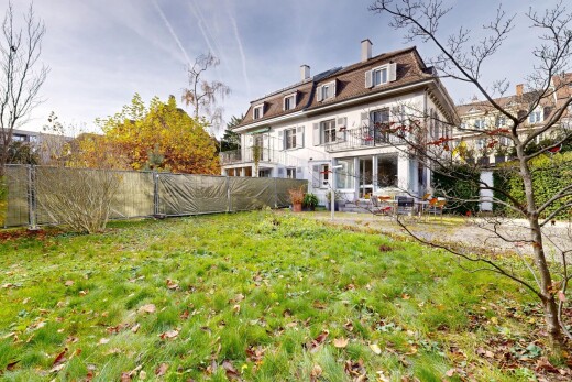 façade avec pelouse, clôture, cheminée, toit mansardé, et from property