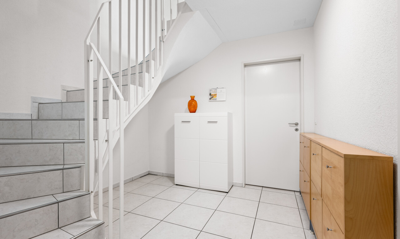 staircase with tile patterned floors and baseboards