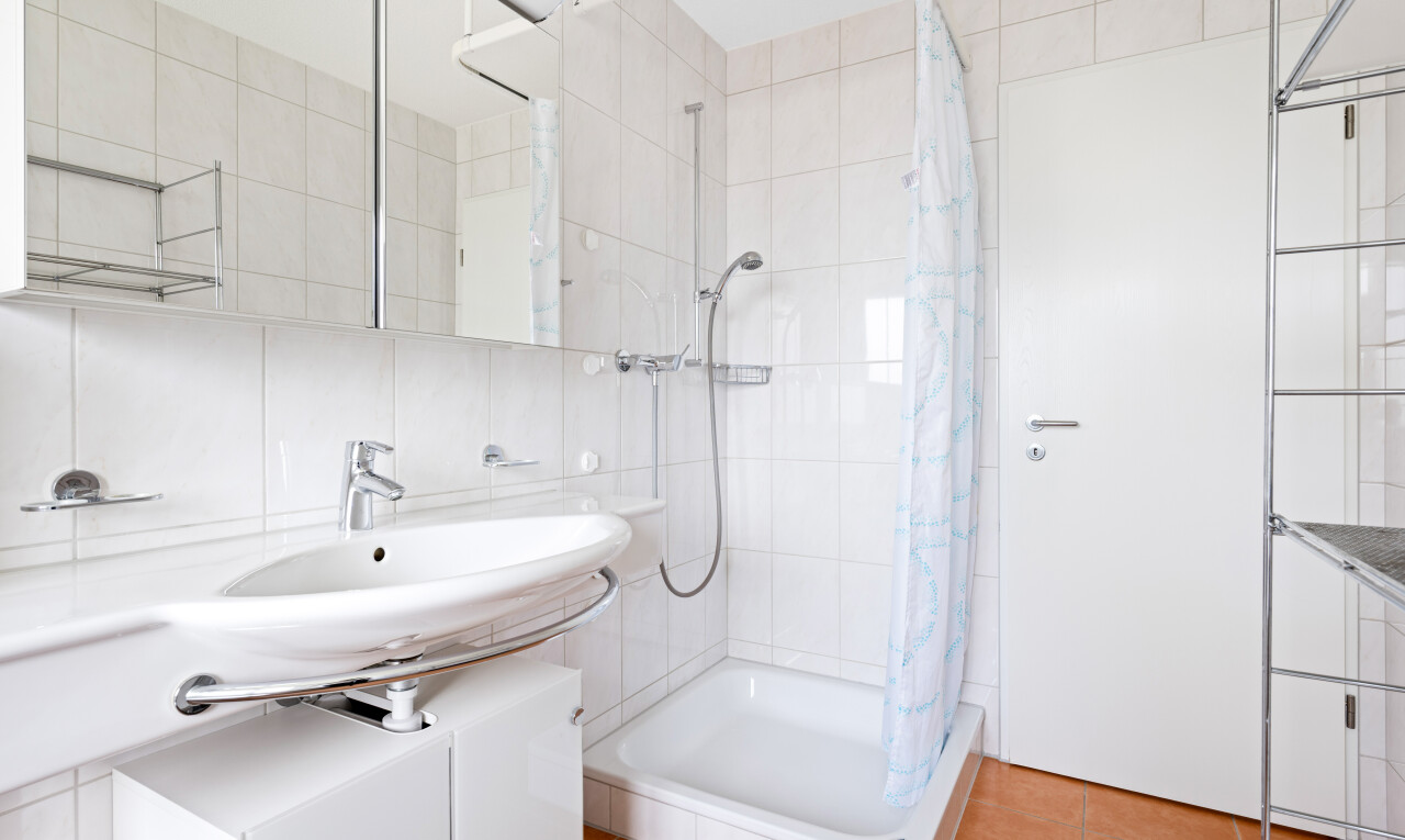 full bath featuring a shower stall, tile walls, and light tile patterned floors