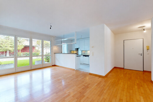 pièce vide avec accès à l'extérieur, drywall, cloison sèche, wood finish floor, et sol en finition bois