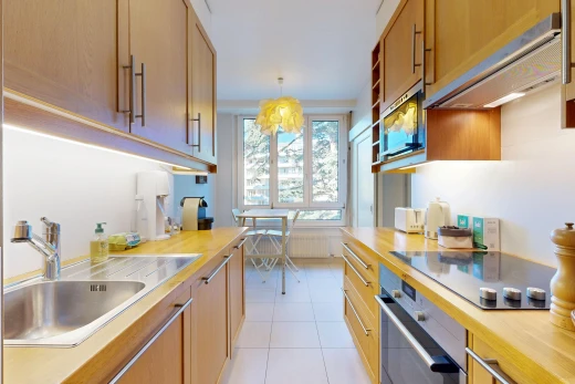 cuisine avec évier, hotte, light countertops, light floor, et four