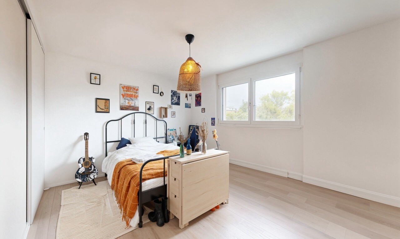 room with light wood-style flooring and a closet