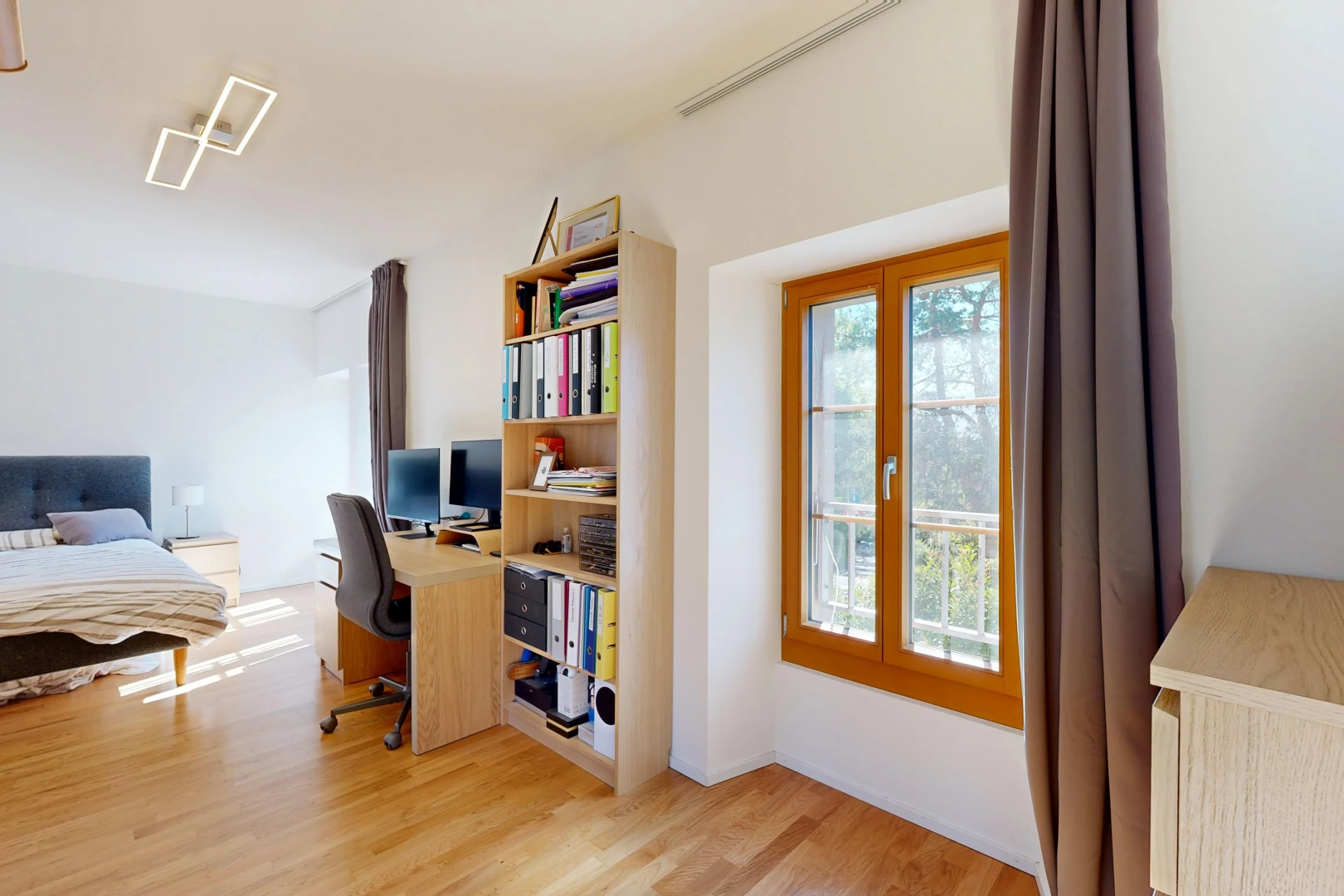 chambre avec espace bureau, drywall, cloison sèche, wood finish floor, et sol en finition bois