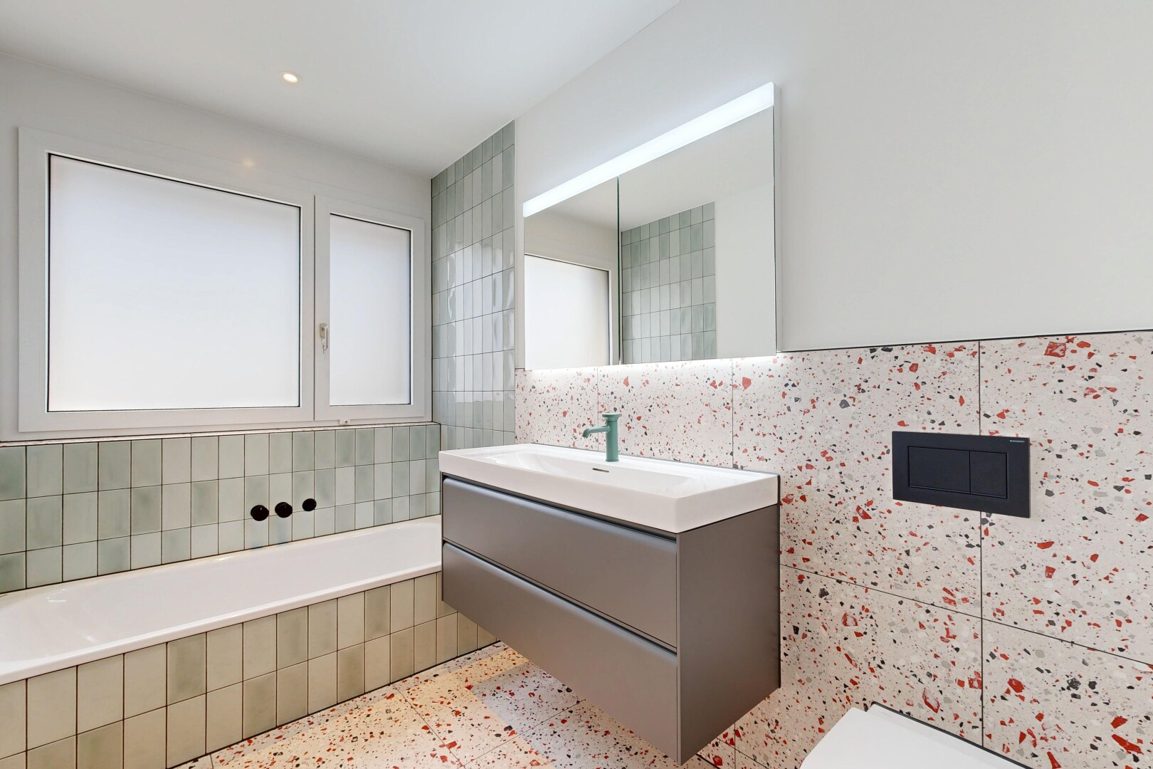 full bath featuring vanity, a bath, tile walls, recessed lighting, and dark speckled floor