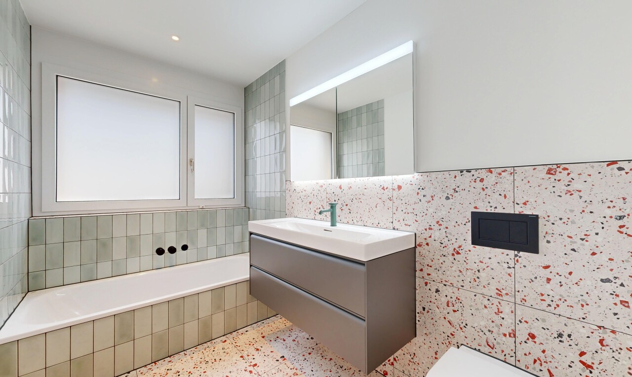 full bath featuring vanity, a bath, tile walls, recessed lighting, and dark speckled floor