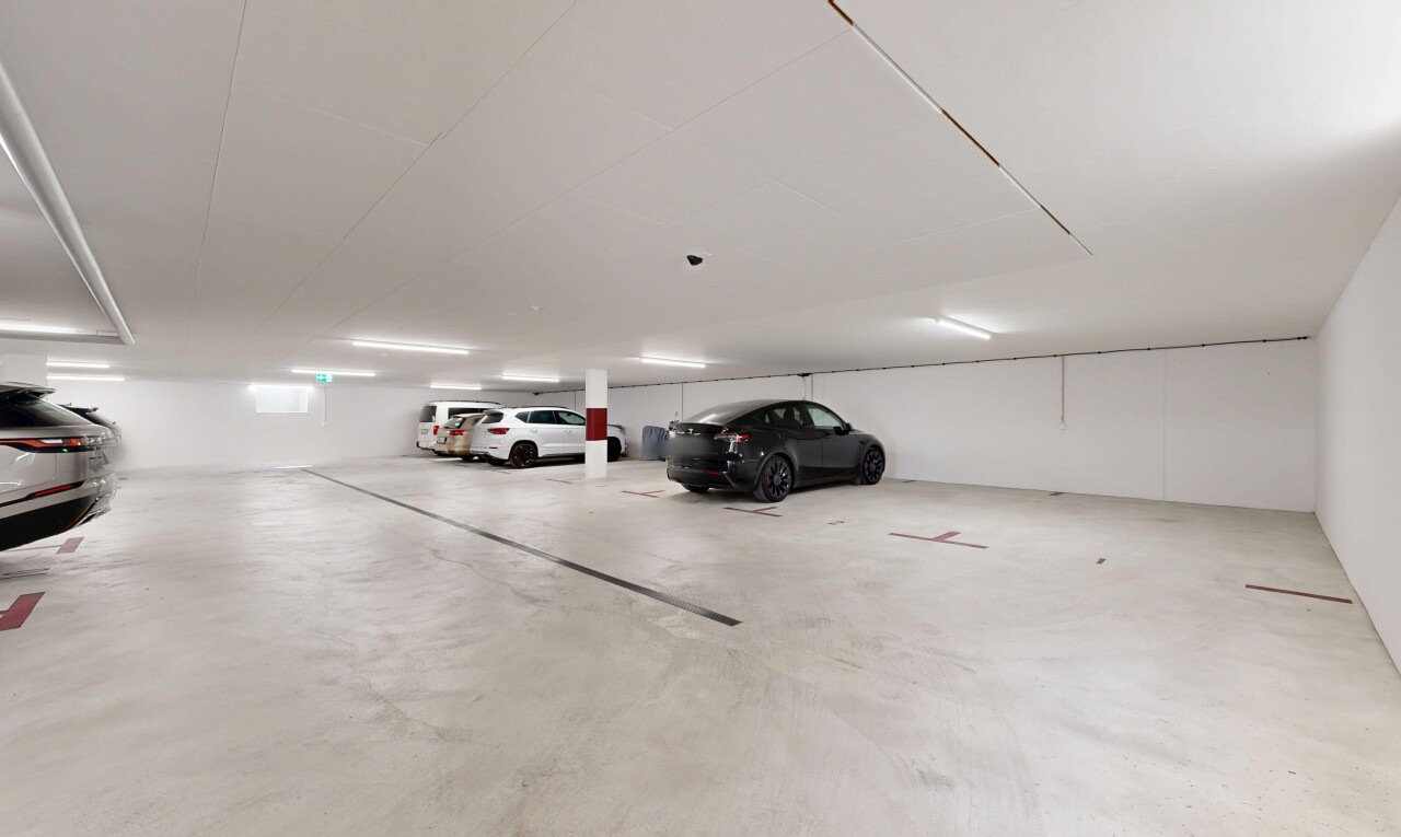 view of parking with a parking garage