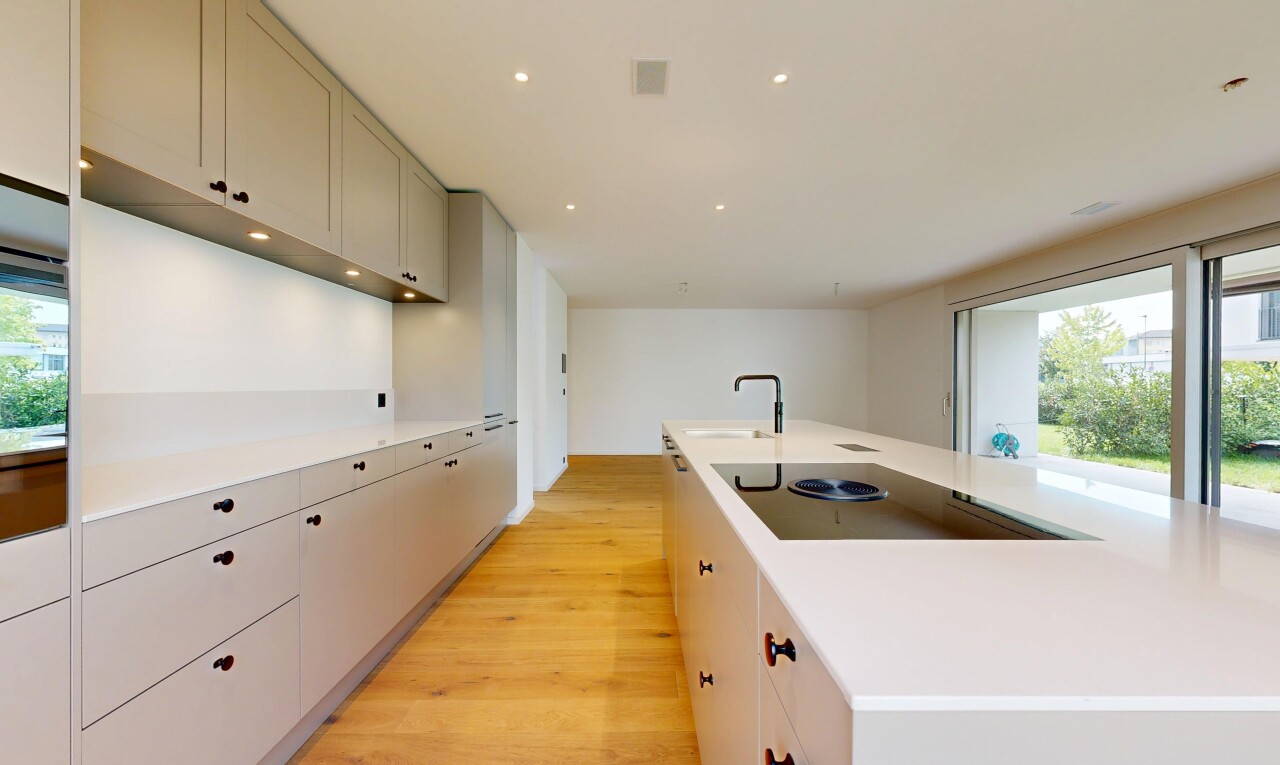 kitchen with light countertops, a large island, recessed lighting, light wood finished floors, and black electric cooktop