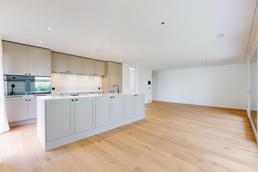 kitchen with light countertops, a kitchen island with sink, light wood-style flooring, recessed lighting, and double oven