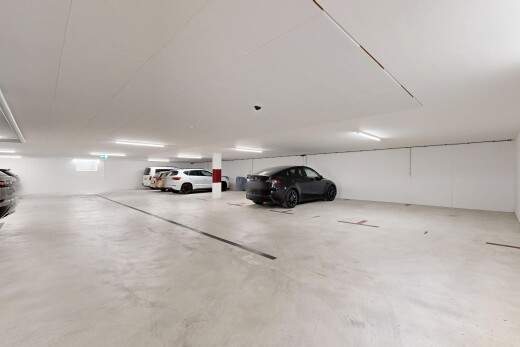 view of parking with a parking garage
