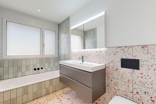 full bath featuring vanity, a bath, tile walls, recessed lighting, and dark speckled floor