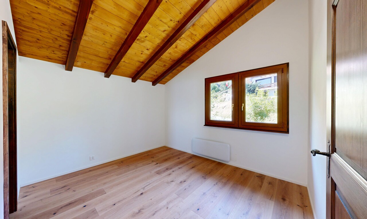 pièce vide avec inside property, plafond à poutres, beamed ceiling, sol en finition bois, et wood finish floor