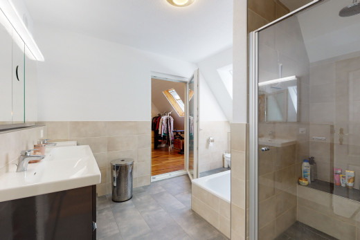 bathroom with tile flooring, dual vanities, and separate shower and tub enclosures