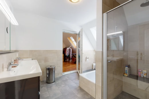 badezimmer mit fliesenböden, zwei waschtisch sowie separate dusche und badewannengehäuse