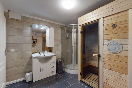 bathroom with tile flooring, mirror, oversized vanity, and shower with shower door