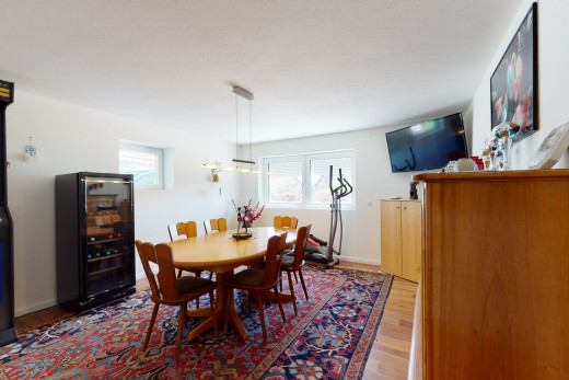 dining room featuring natural light, wood-type flooring, and TV