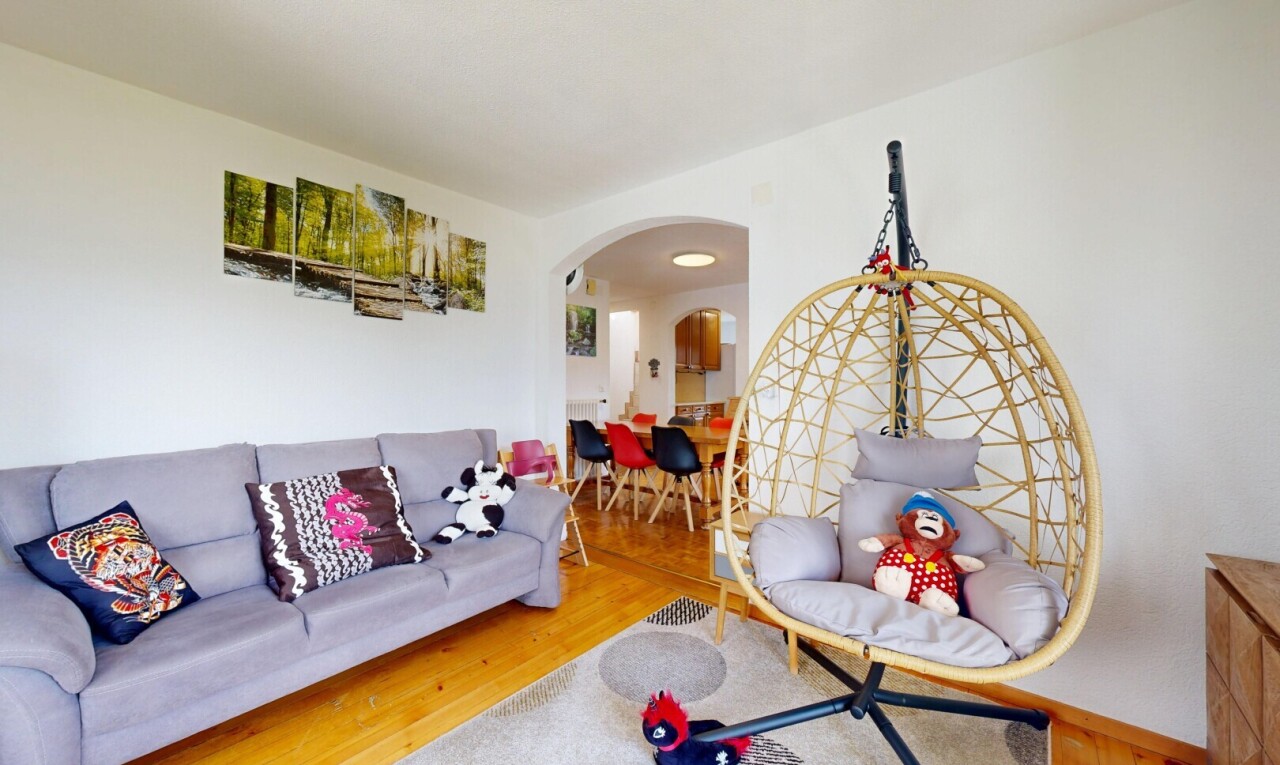 wohnzimmer mit gewölbte gehwege, drywall, gipskartonwand, wood finish floor, und holzfußboden