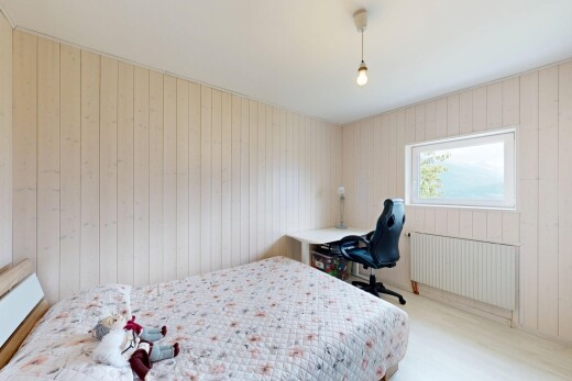 room / bedroom featuring wooden walls, radiator, and decorative light fixtures