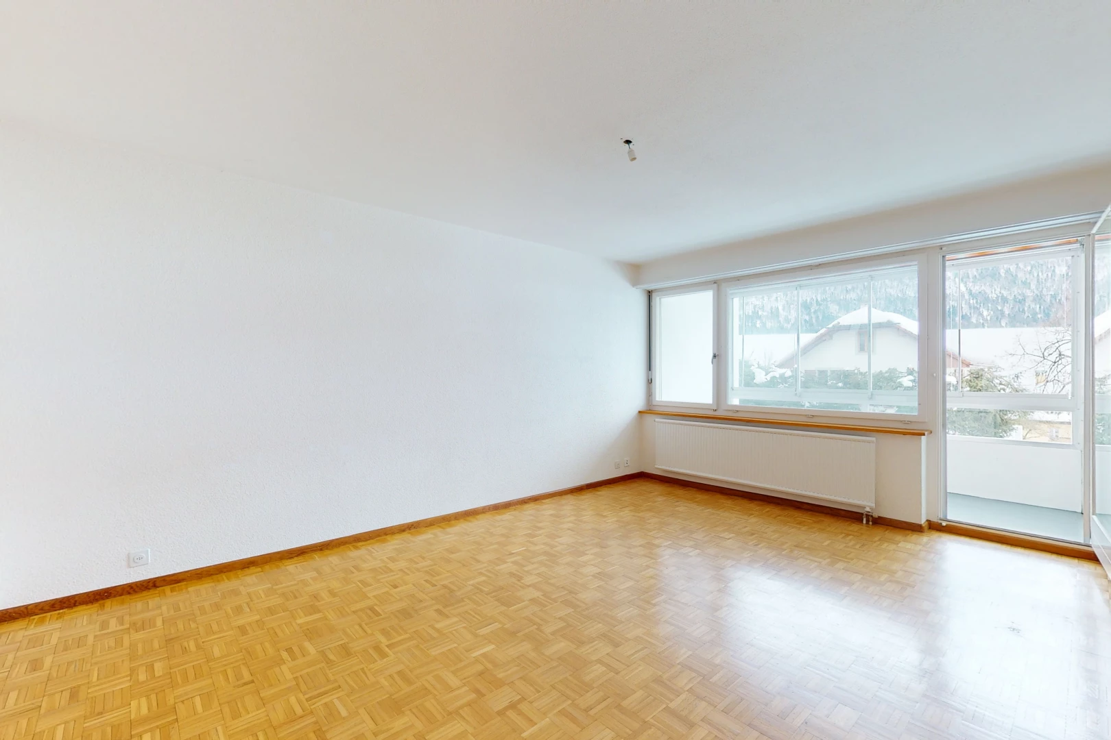 hardwood floored empty room featuring natural light