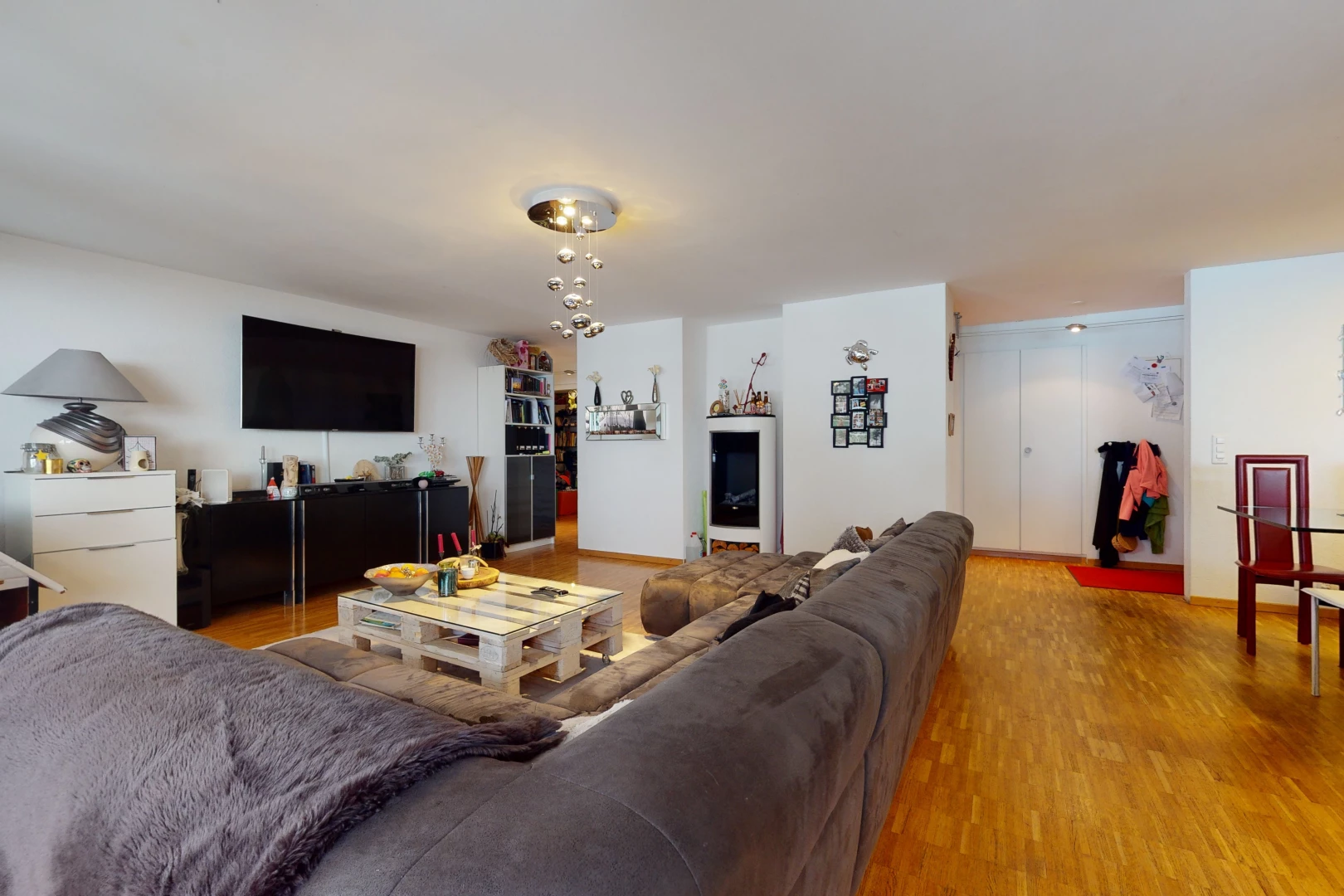 hardwood floored living room featuring TV