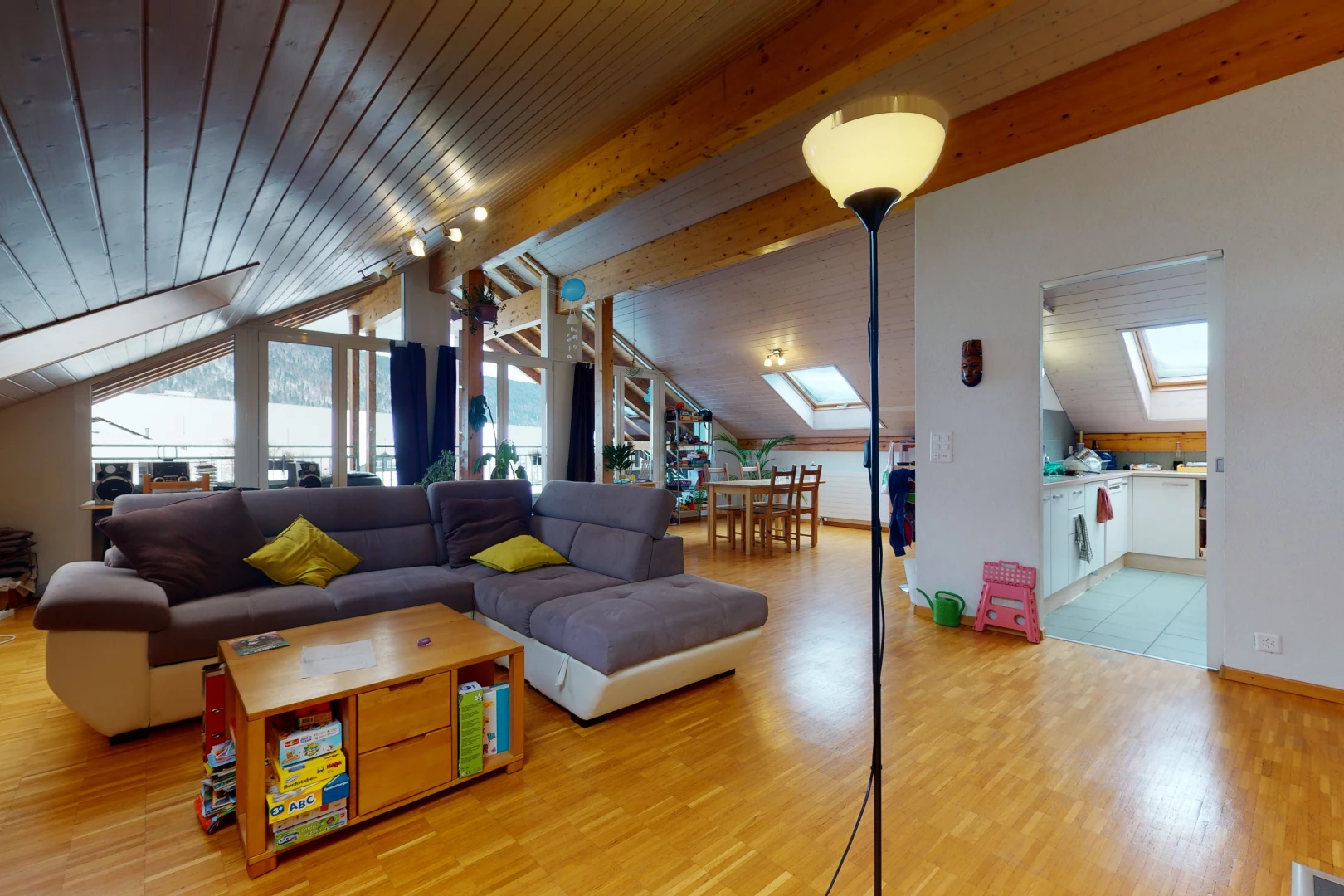 living room featuring natural light, wood beam ceiling, and tile floors