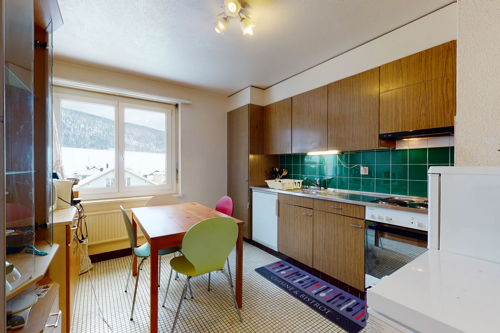 kitchen featuring natural light, oven, light flooring, and light countertops